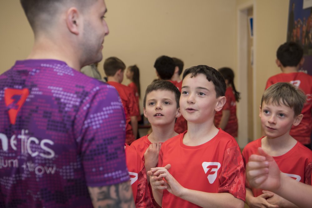 Children taking part in funetics activity with leader