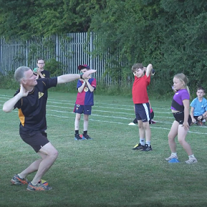 young athletes being coached shot put at Houghton Harriers