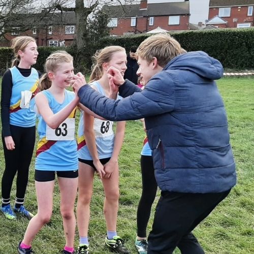 Alex Wilson, a young coach, celebrating with athletes