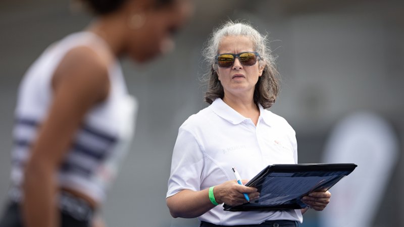 Official with clipboard and athlete