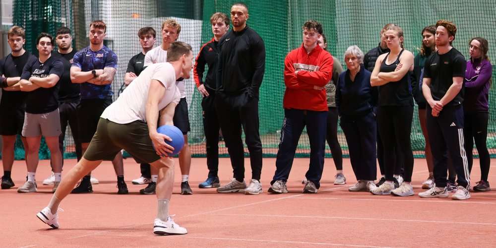 Thomas Roehler demonstrating medicine ball at javelin masterclass