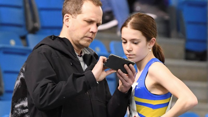 Coach and young athlete