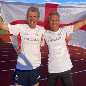 England Masters team mates holding England flag at Deeside 3000m