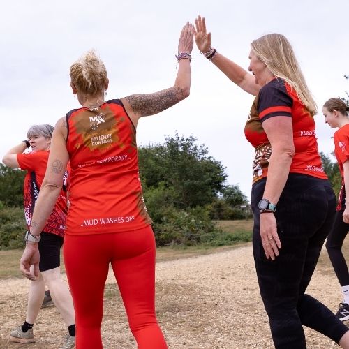 Muddy Runners group members high fiving